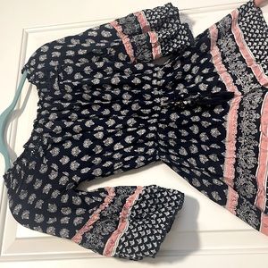 pink, blue, and white romper with belt tie to tighten or stretch.